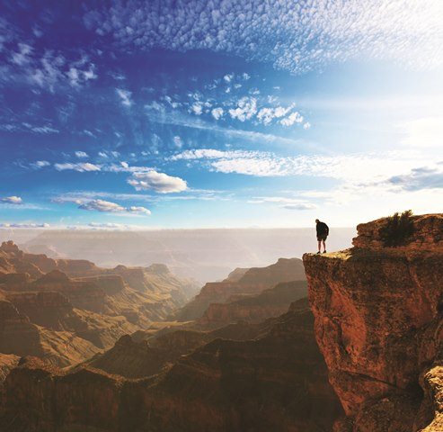 Man looking over the cliff in the Grand Canyon