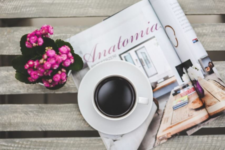 Coffee and flowers on a magazine